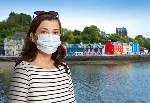 Travelling During The Corona Or Covid Pandemic: Woman Tourist Wearing Protective Face Mask At Tobermory, Mull Island, Scotland.