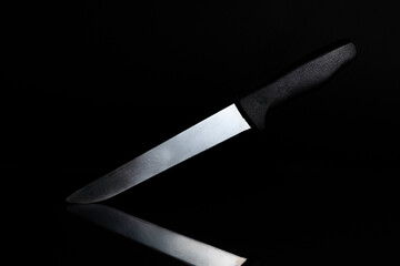 Knife on a black background with reflection for product illustration