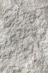 Empty rough, uneven texture of a gray concrete wall close up with copy space