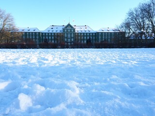 snow field and a classical European building in Szczecin Poland