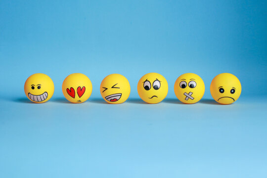 Various hand painted yellow emoticon isolated on blue background