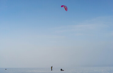 Sailing snowboard on a frozen lake. Winter sports.