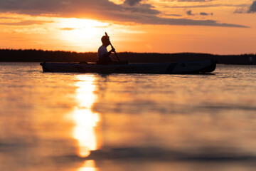 Naklejka na ściany i meble Kayaking in sunset 
