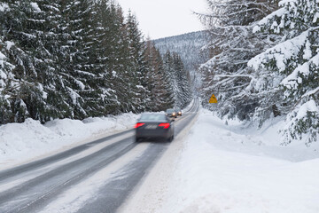 Asfaltowa droga przebiegająca przez Góry Izerskie. Polska zimą.