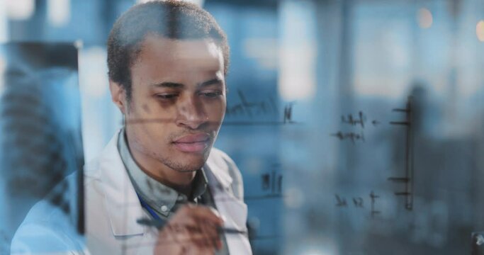 African american young doctor successful intern working in contemporayry hospital coworking space creating new ideas and learning.