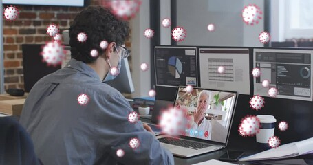 Animation of covid 19 cells over man in face mask using laptop on video call - Powered by Adobe