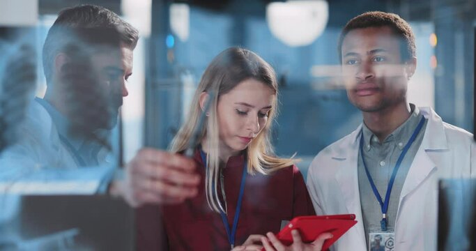 Professional multi-race medical staff with female nurse using tablet computer brainstorming sulutions for influenza coronavirus disease in modern office hospital.