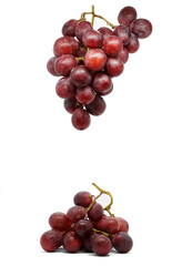 Hanging bunch of red grapes and another bunch of red grapes below. Isolated on white background.