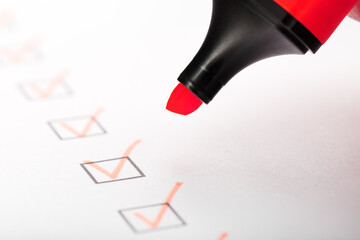 Orange marker with markers on the checklist sheet.