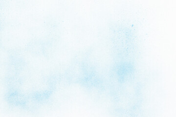 blue spray paint on white paper background