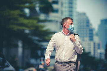 professional adult businessman wearing surgical face mask to protect of coronavirus covid-19,...