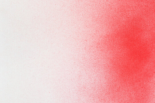 spray paint red on a white paper background
