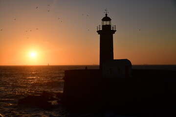 Sunset with a lighthouse in the background