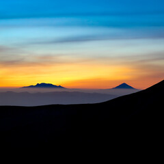 View of the Iztaccíhuatl volcano and Popocatépetl volcano from the Nevado de Toluca. Beautiful sunrise of the volcanoes