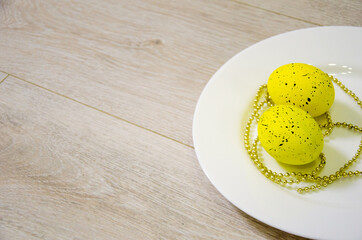 multicolored eggs on a white background covered with sparkles. easter holiday concept