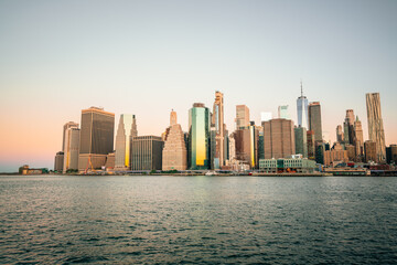 Fototapeta na wymiar sunrise clear sky city new york buildings reflections sun sea beautiful summer