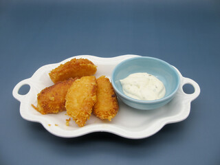 Golden breaded fried cheese sticks and garlic sauce