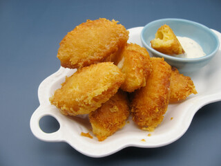 Golden breaded fried cheese sticks and garlic sauce