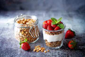 Strawberry Greek yogurt granola parfait in a glass