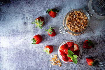 Strawberry Greek yogurt granola parfait in a glass