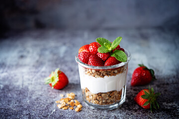 Strawberry Greek yogurt granola parfait in a glass