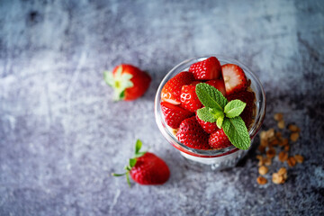 Strawberry Greek yogurt granola parfait in a glass