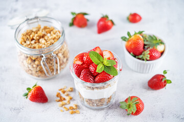 Strawberry Greek yogurt granola parfait in a glass