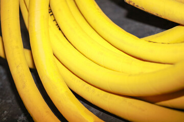 The yellow hose tube is coiled into a bundle.