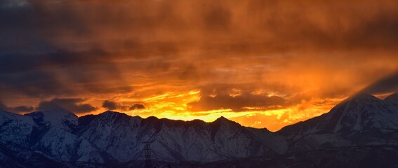 Sunrise view of winter panorama. Snow capped Mt Timpanogos in the Wasatch Front Rocky Mountains, Great Salt Lake Valley and Cloudscape. Provo, Utah, United States.