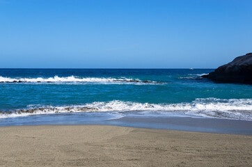 Landscape of the blue sea with a coastline with sand