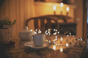 Cup of coffee in romantic dark interior