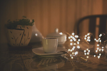 Cup of coffee in romantic dark interior