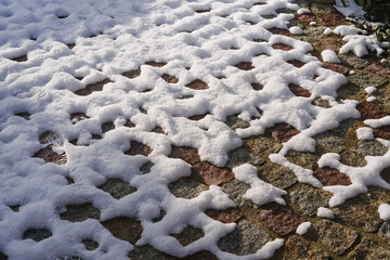 backyard made of granite cubes covered with snow 