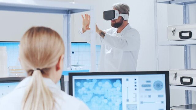 Genetic engineers are using Virtual Reality technology. Professional team of scientists is working on a vaccine in a modern scientific research laboratory. Science of future.