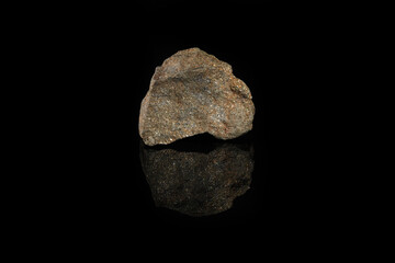 Mineral chalcopyrite, copper pyrite from Grekhovskoe, Altai, Russia on black glass background. Copper pyrite composed of iron, copper, and sulfur.
