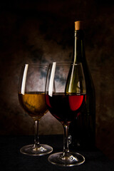 glass with red and white wine at dark
