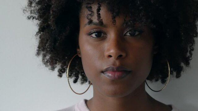 Portrait of a beautiful black woman with afro on the white background