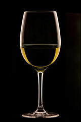Glass of wine on black background.