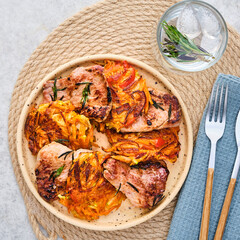 Roasted veal with rosemary and vegetable garnish. Top view.