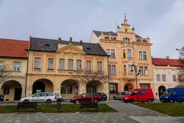 Fototapeta premium Narrow medieval square with baroque and renaissance historical buildings, cityscape of medieval town in sunny winter day, Benatky nad Jizerou, Central Bohemian, Czech Republic