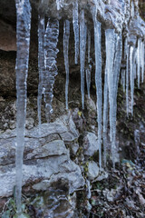 Icicles hanging off of a rock, winter landscape at lessinia park