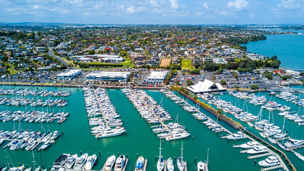 Aerial view on a marina with a residential suburb in the background. Auckland, New Zealand.