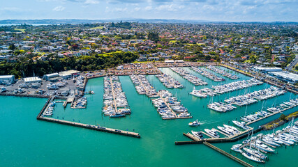 Obraz premium Aerial view on a marina with a residential suburb in the background. Auckland, New Zealand.
