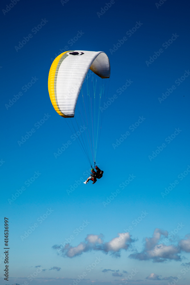 Poster Europe, Austria, Dachstein, Paraglider soaring above Lake Hallstatt and the surrounding mountains, all of which is part of the Salzkammergut Cultural Landscape, UNESCO World Heritage Site