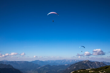 Europe, Austria, Dachstein, Paragliders soaring above Lake Hallstatt and the surrounding mountains, all of which is part of the Salzkammergut Cultural Landscape, UNESCO World Heritage Site