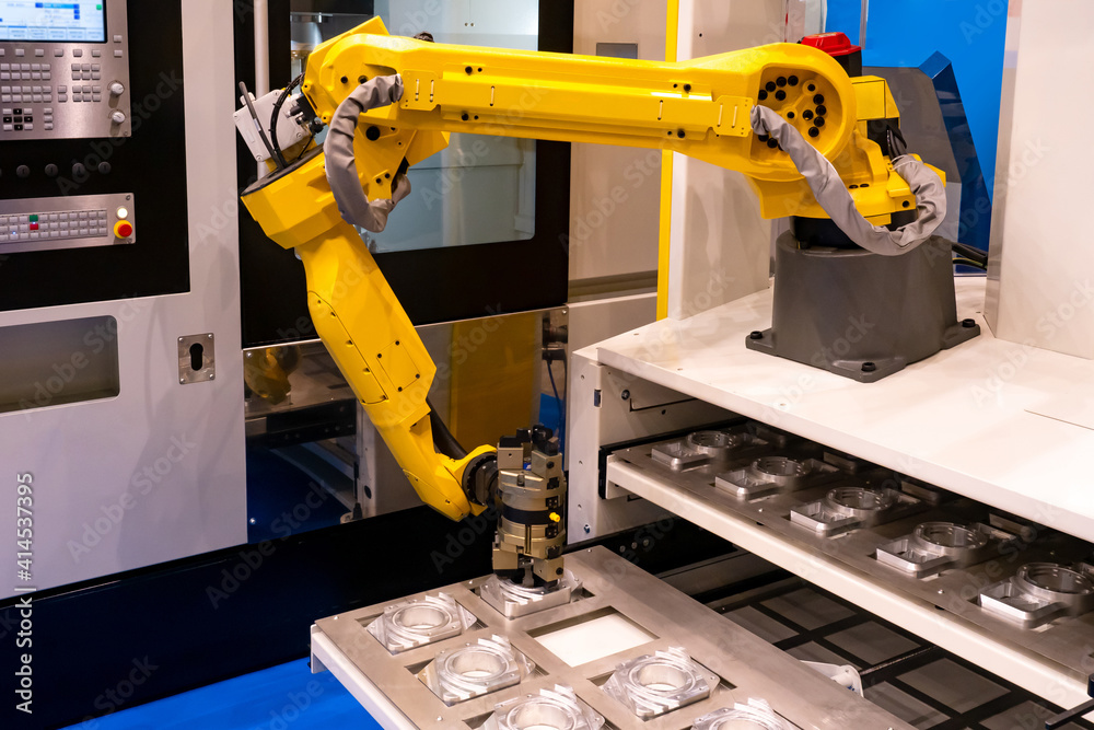 Poster robot manipulator during metal processing. yellow robotic arm in an enterprise. assembly of complex 