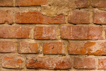 old brick wall of a house with plaster