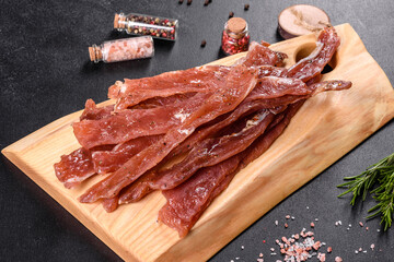 Tasty hearty meat salted and dried with pieces of spices and herbs