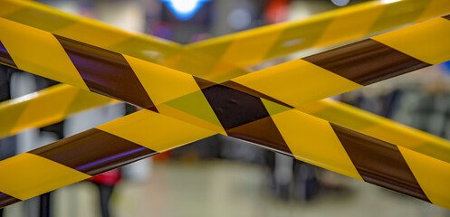 Barrier tape for no entry at an quarantine area .do not cross ribbons. Yellow and black danger tapes