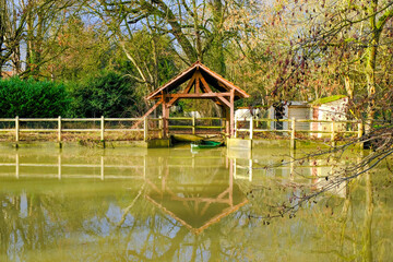 Boathouse on a small river seen from nearby